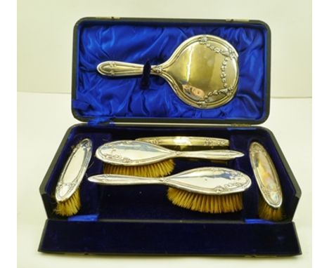 JOSEPH GLOSTER LTD. A SILVER BACKED SIX PIECE LADY'S DRESSING TABLE BRUSH SET, each item with pressed vine decoration compris