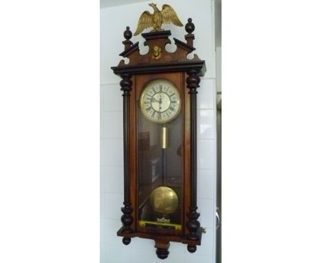 A VIENNA WALL CLOCK, with gilded eagle crest, the dial with Roman numerals, 125cm high 