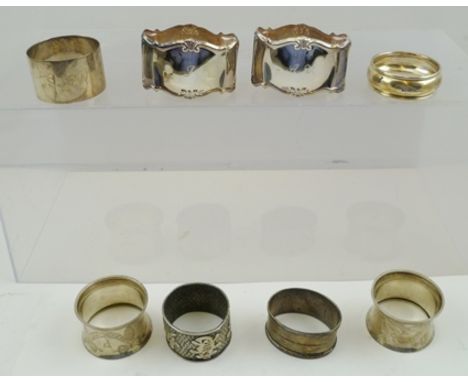 A SELECTION OF SILVER AND SILVER COLOURED METAL ENGLISH AND CONTINENTAL NAPKIN RINGS to include; two pairs in foreign silver 