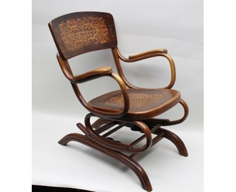 A "THONET" BENTWOOD ROCKING CHAIR, raised on sprung frame, having decorative back support panel and seat, bears printed manuf