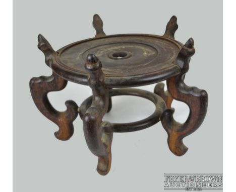 A large Chinese hardwood stand, formed of five 's' scroll supports on circular stretcher, top 28cm diam