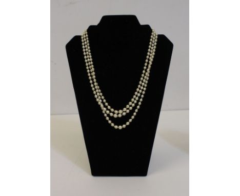 A cultured pearl three stand graduated necklace, silver clasp with paste stones