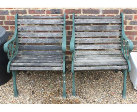 A pair of vintage cast metal sided chairs with one piece slated seats and back