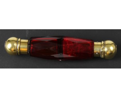 An unusual late 19thC ruby coloured faceted glass and gold and silver gilt double ended scent bottle, of barrel shape with go