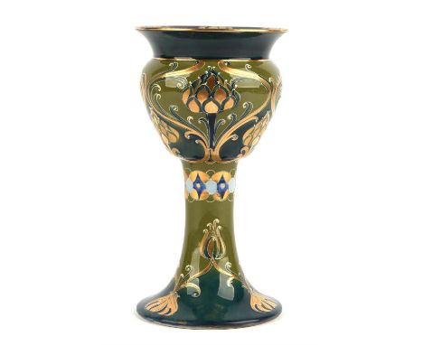 WILLIAM MOORCROFT (1872-1945) FOR MACINTYRE & Co, a large pottery goblet decorated in the green and gold Florian Dahlia patte