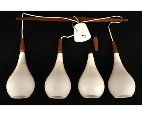 HOLMEGAARD, a three light chandelier, with white glass bulb shaped shades, suspended from a teak arm, 65.5cm wide, with a spa