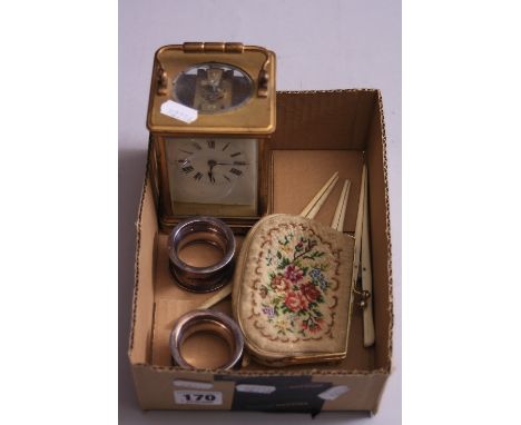 A BRASS CARRIAGE CLOCK, together with two silver napkin rings, three glove stretchers and a purse