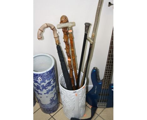 A CERAMIC STICK STAND, containing six walking sticks/canes, to include silver topped