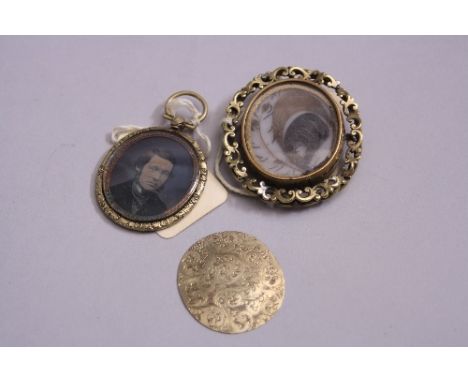 TWO VICTORIAN PINCHBECK BROOCHES, a double sided mourning brooch of oval form containing locks of hair within scrolling borde