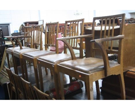 A SET OF TEN 'ACORNMAN' OAK FRAMED DINING CHAIRS, with stick backs, shaped top rail and square chamfered tapering front suppo