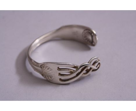 A NOVELTY SILVER BRACELET, made from a fork