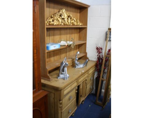 A VICTORIAN PINE DRESSER BASE, with central cupboard and seven various drawers, the later plate rack with two spice drawers, 