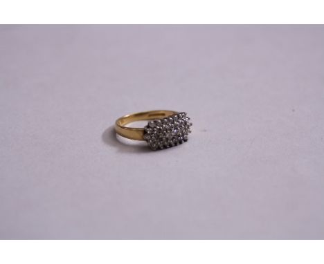 A MODERN DIAMOND RECTANGULAR SHAPE CLUSTER RING, claw set in white gold to tapering yellow gold shoulders and a plain D shape