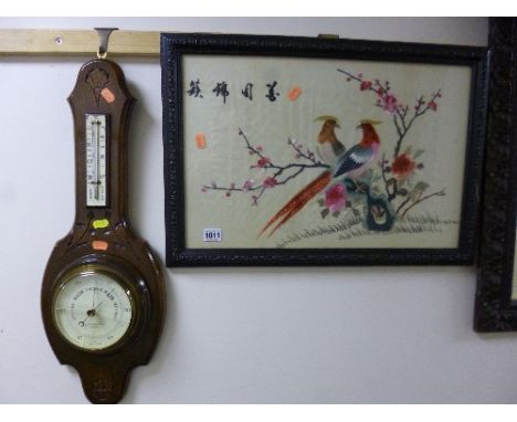 AN ORIENTAL SILK EMBROIDERY, birds in paradise on branches with blossom, four character script mark, approximate size 32.5cm 