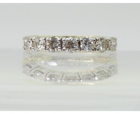 A HALF ETERNITY RING mounted in 18ct yellow and white gold and set with estimated approx 1ct of brilliant cut diamonds, finge