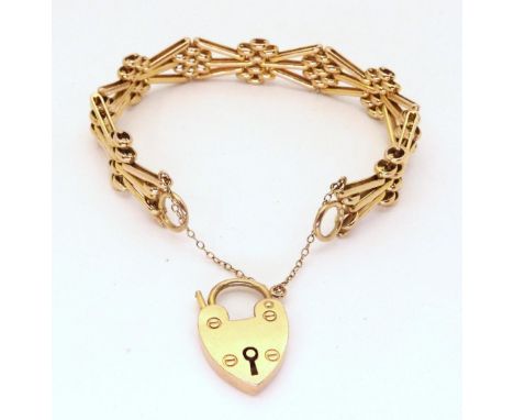 A 9CT GOLD GATE BRACELET with a fancy pattern to the bars and a heart shaped clasp, length 19.5cm, weight 31gms Condition Rep
