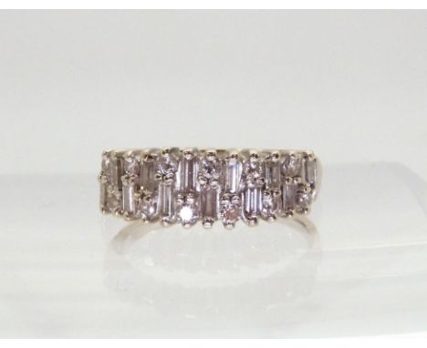 AN 18CT ETERNITY RING An 18ct white gold baguette and brilliant cut half eternity ring, set with estimated approx 0.78cts, fi