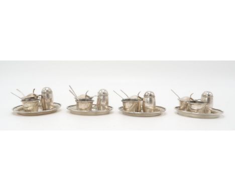 A CHINESE SILVER CRUET SET Decorated with bamboo, comprising; four saucers, 8.5cm diameter, four pepper pots, 4cm high, four 