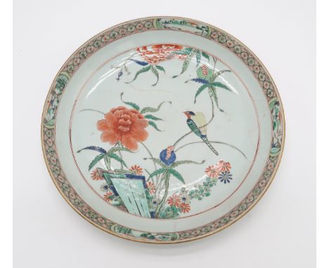 A CHINESE EXPORT FAMILLE VERTE DEEP DISH the well decorated with a bird amongst flowers, surrounded by a band of floral lozen