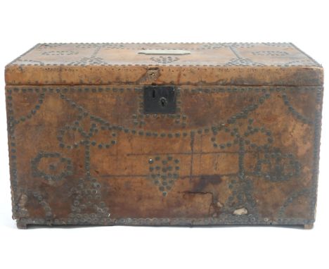 A LATE 18TH/EARLY 19TH CENTURY BRASS STUDDED CHEST&nbsp; bound in hide with wrought iron carry handles, chest mounted with br
