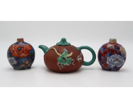 A CHINESE YIXING TEAPOT of gourd form, decorated and enamelled in relief with foliage and birds, 19.2cm wide, 11cm high, toge