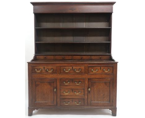 AN 18TH CENTURY OAK WELSH STYLE KITCHEN DRESSER&nbsp; with corniced top over three open plate shelves over four shallow drawe