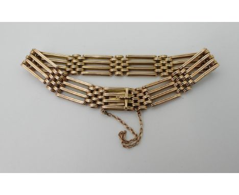 A GATE STYLE BRACELET with a box clasp, stamped 15c to the back of the tongue. Length 19cm, width approx 1cm. weight 20.1gms 
