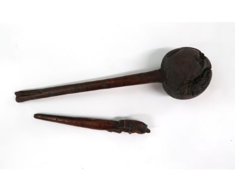 A POLYNESIAN CLUB  The globe shaped knop on carved handle, 38cm long and a carved pointer with seated figure handle, 23cm lon