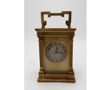 A FRENCH BRASS AND GLASS CARRIAGE CLOCK the silvered dial with Arabic numerals, the case with an acanthus topped column to ea