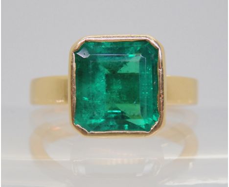 AN EMERALD RING The 3.21ct square step cut emerald comes with a certificate from the GCS, which states, the emerald is 9.58mm