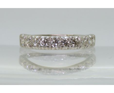 A HALF ETERNITY RING the 18ct white gold shank set with ten brilliant cut diamonds, with an estimated approx diamond carat we