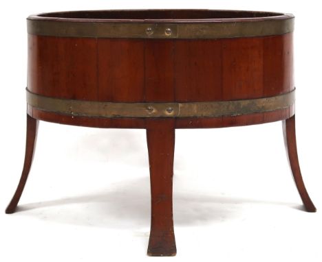AN EDWARDIAN TEAK AND BRASS COOPERED ALEX HAMILTON LONDON OVAL PLANTER&nbsp; with galvanised removable liner on splayed suppo