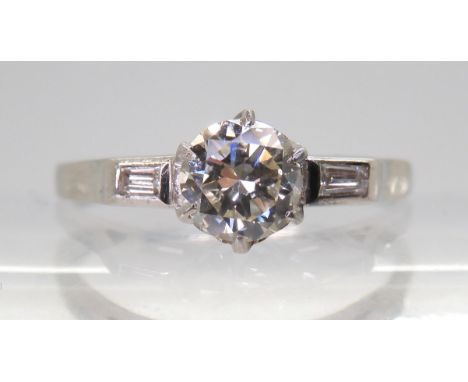 A CLASSIC VINTAGE DIAMOND RING set with an estimated approx 0.58ct brilliant cut diamond, with further baguette cut diamonds 