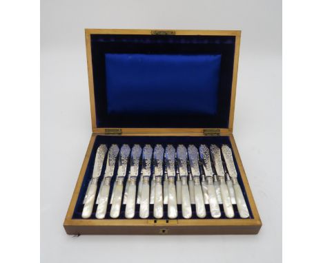 A CASED SET OF EDWARDIAN SILVER MOTHER OF PEARL FISH KNIVES AND FORKS the blades by Fenton Brothers, Sheffield 1901, the coll