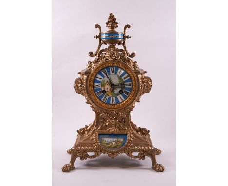 A French gilt metal eight day mantel clock striking on a bell, the case ornately cast with Classical motifs and inset porcela