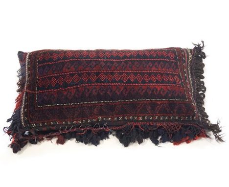 A Middle Eastern tasslled carpet cushion, 50cm x 100cm wide 