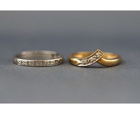 Two rings, comprising; a vintage small diamond three stone band ring, set in white stamped ‘18ct’, size M, 1.2g gross; and a 