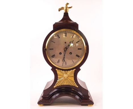 A 19th century mahogany balloon shaped mantel clock, the eight day movement with bell strike, the case surmounted by a gilt m