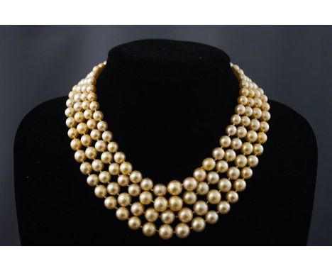 A cultured pearl four row choker with a ruby and diamond clasp, the graduated rows of 43, 43, 42 & 47 cream/yellow beads grad