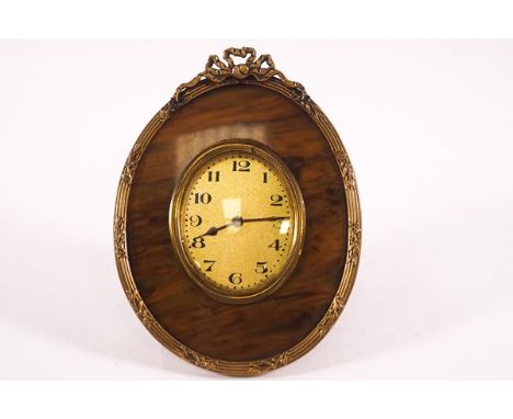 A French gilt metal and tortoiseshell oval bedside clock, 12cm high