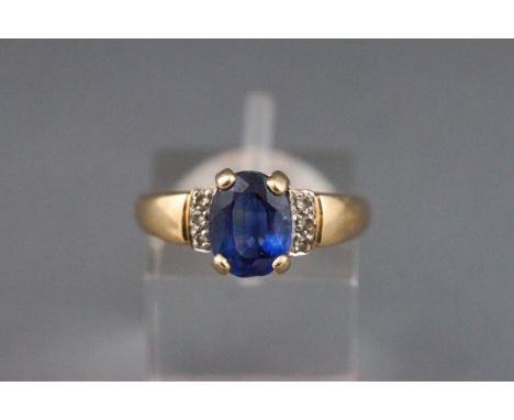 A 9ct gold, sapphire and diamond dress ring, centred with an oval native-cut sapphire approx. 2.15cts, claw set between round