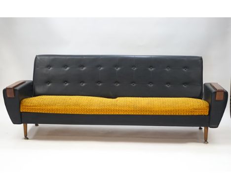 A 1970's button back black leatherette and fabric sofa, 74cm high x 208cm wide x 86cm deep, together with a pair of matching 