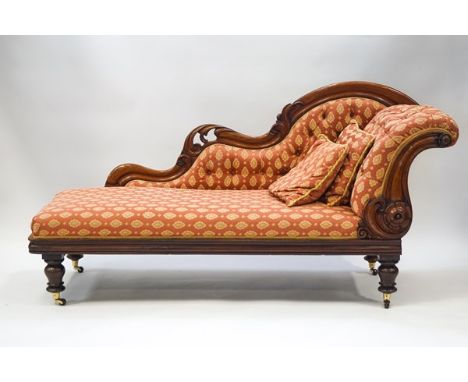 A Victorian mahogany show frame chaise longue with button back, on turned legs with brass and ceramic casters, 97cm high x 19