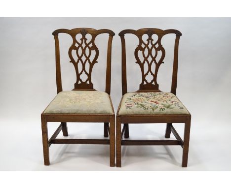 A pair of George III style mahogany dining chairs with Chippendale style carved and pierced splats, tapestry upholstered seat
