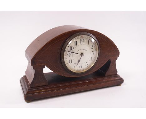 An Edwardian mahogany mantel clock of eye shape, the dial signed Walker and Hall, 26cm wide