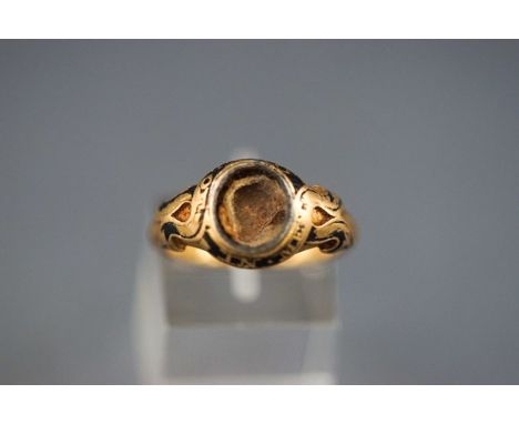 An early Victorian 18ct gold and enamel mourning ring, the oval hollow head formerly with a glazed woven hair panel (now miss