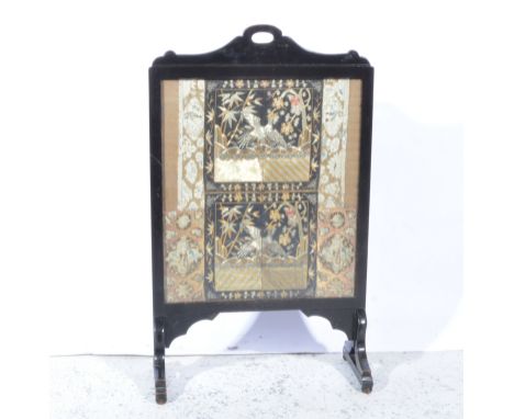 Ebonised fire screen incorporating fragments of Chinese embroidery, width 53cm, with another, (2).