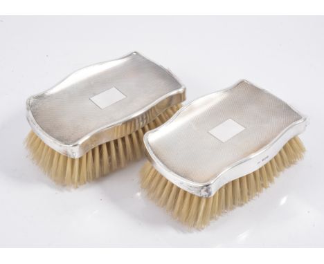 A pair of silver backed brushes, engine turned design with vacant rectangular initial plate, hallmarked Birmingham 1975, make