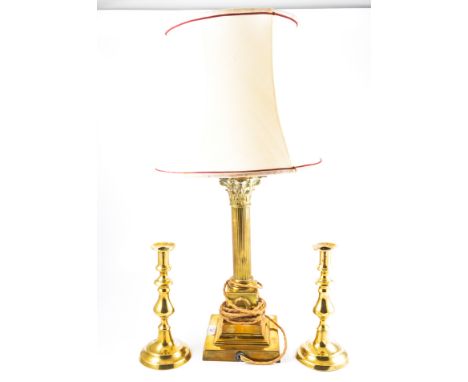 Brass Corinthian column table lamp, with shade, 62cm overall; a pair of Victorian brass candlesticks; and a brass companion s