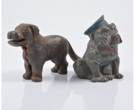 Cast iron novelty money box in the shape of a bull dog, along with a cast iron novelty nut cracker in the shape of a dog.